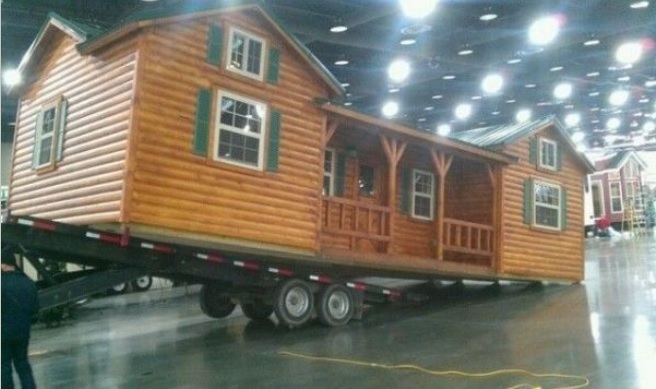 Amish log cabin kit loaded on a trailer ready for delivery